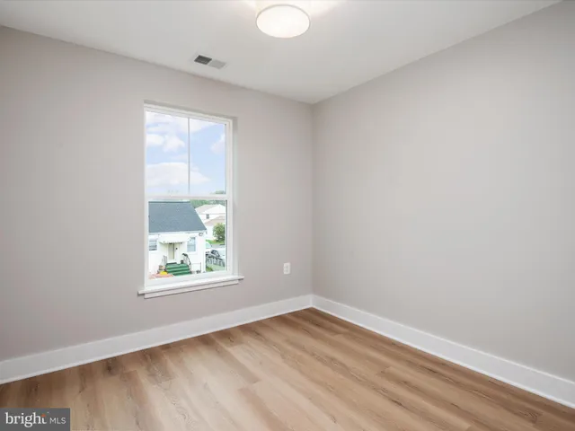 a view of an empty room and wooden floor