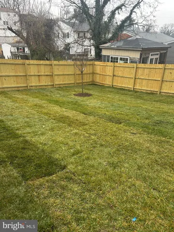 a view of a house with a big yard and sitting area