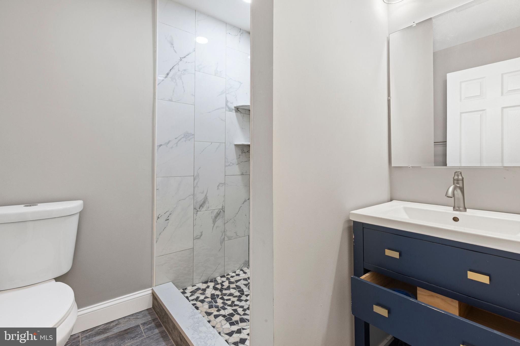 3725 Overview Road Baltimore, MD 21215 - Photo 12 of 17 a bathroom with a toilet a sink and a mirror