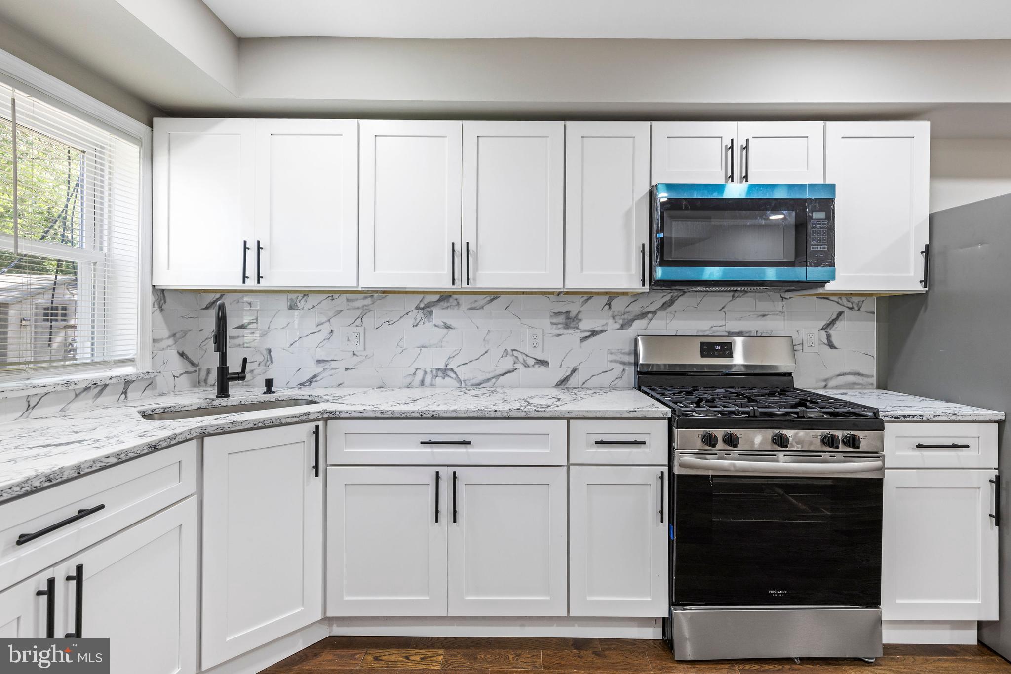 3725 Overview Road Baltimore, MD 21215 - Photo 5 of 17 a kitchen with white cabinets and appliances