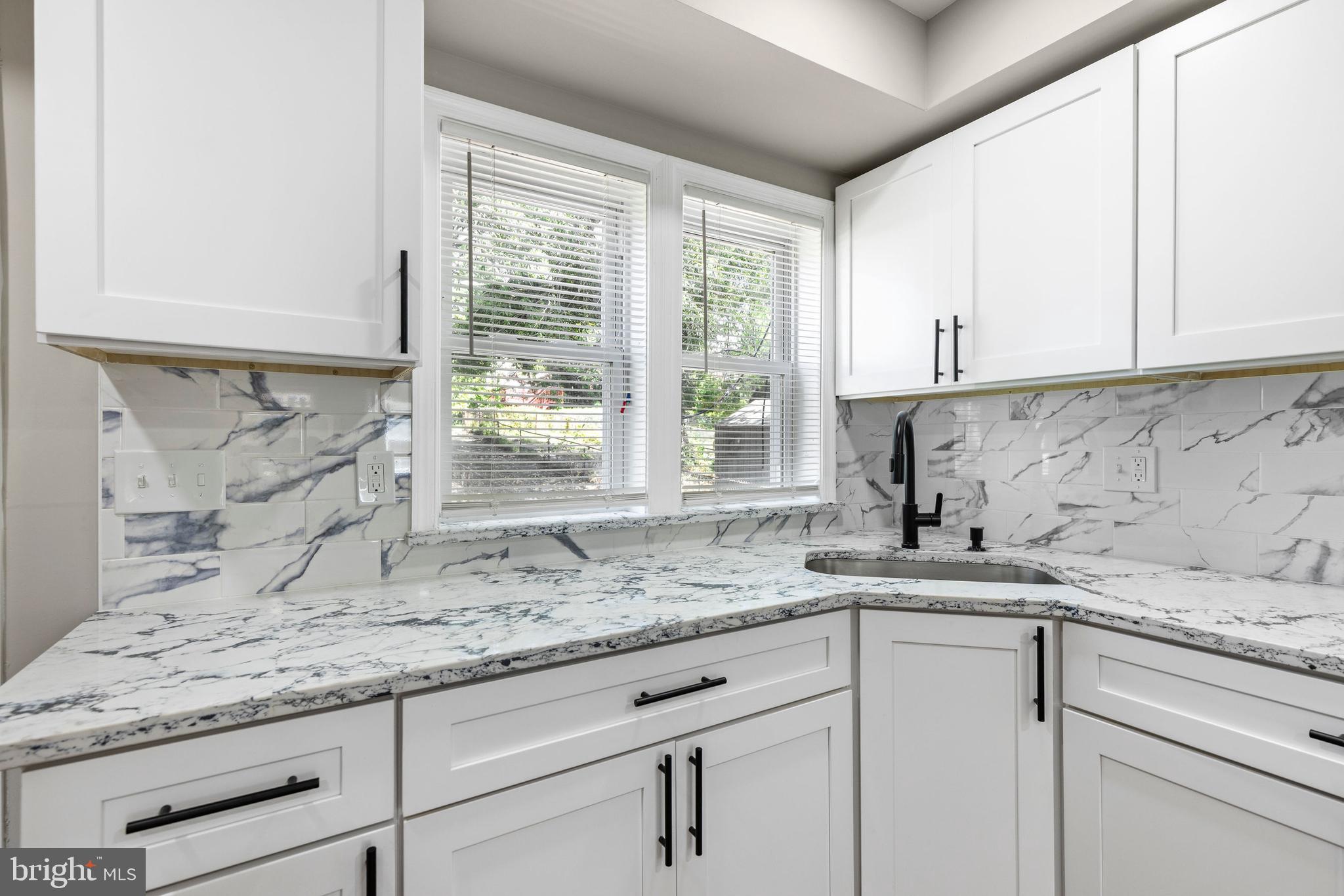 3725 Overview Road Baltimore, MD 21215 - Photo 6 of 17 a kitchen with granite countertop white cabinets and a window