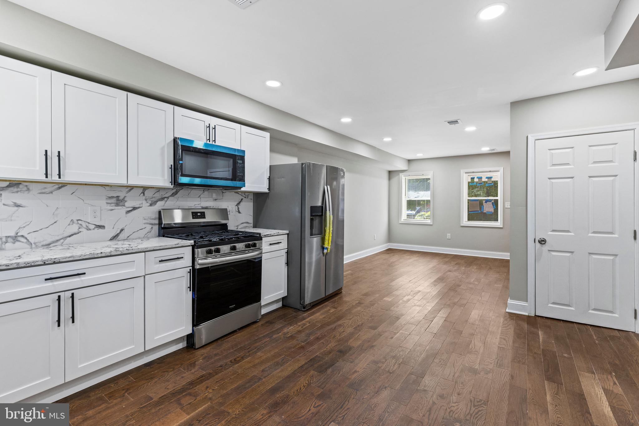 3725 Overview Road Baltimore, MD 21215 - Photo 7 of 17 a kitchen with stainless steel appliances granite countertop a stove a sink and a refrigerator