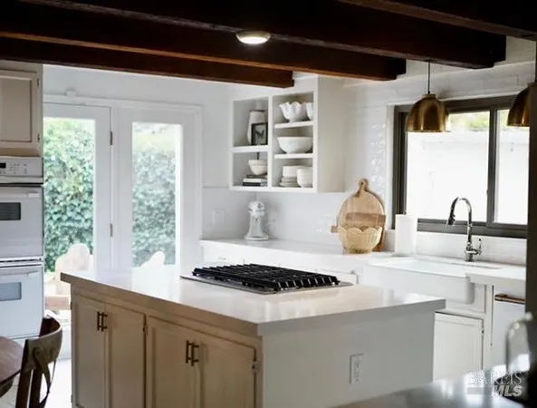 a kitchen with a sink a window and cabinets