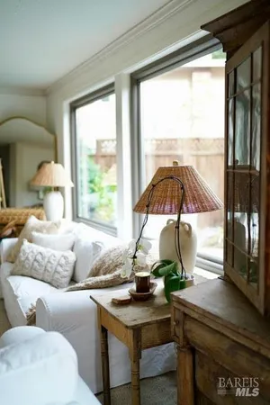 a living room with a couch a table and a large window