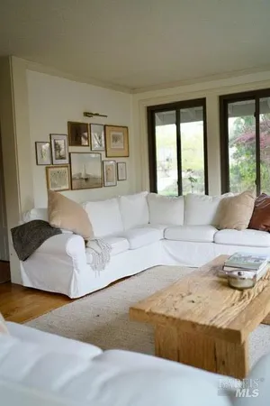 a living room with furniture and large window