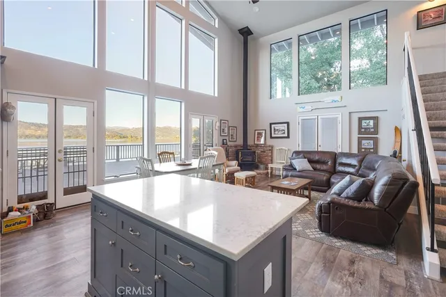 a dining room with furniture a chandelier and wooden floor