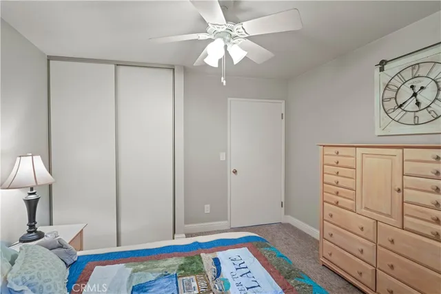 a bedroom with a bed and glass door