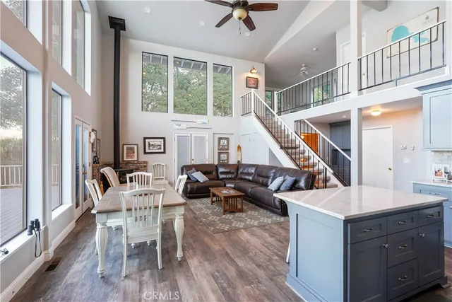 a kitchen with stainless steel appliances granite countertop a refrigerator a stove a sink and a cabinets