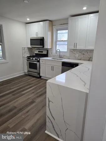 a kitchen with a sink and a stove top oven