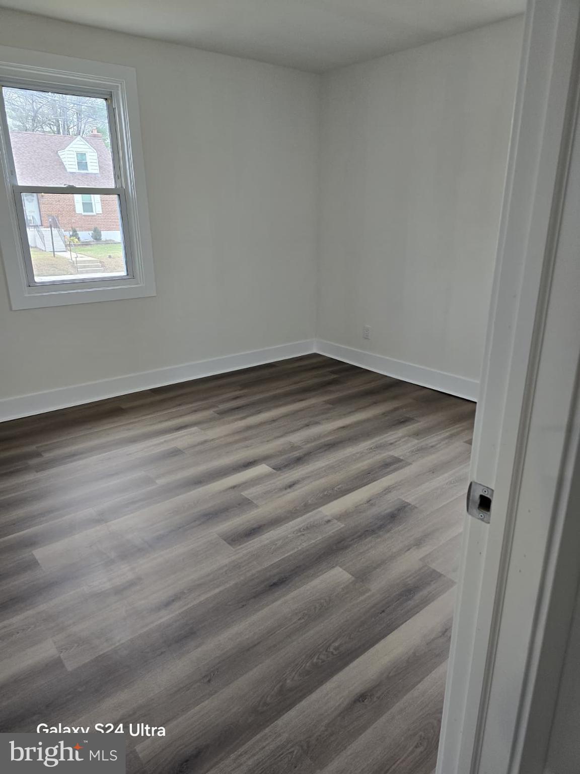 3303 Fairview Road Gwynn Oak, MD 21207 - Photo 7 of 12 a view of a room that has wooden floor and window