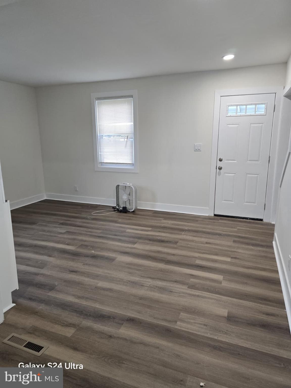 3303 Fairview Road Gwynn Oak, MD 21207 - Photo 8 of 12 a view of an empty room with wooden floor and a window