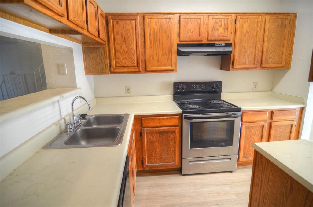 10500 Lake June Road, Unit B07 Dallas, TX 75217 - Photo 2 of 6 a kitchen with granite countertop a stove and a sink