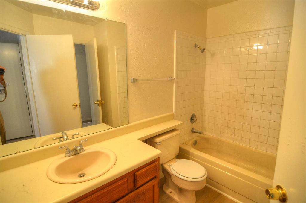 10500 Lake June Road, Unit B07 Dallas, TX 75217 - Photo 5 of 6 a bathroom with a granite countertop sink a toilet and shower
