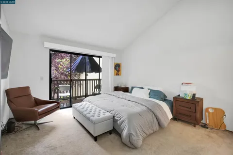 a bedroom with a bed and a large window