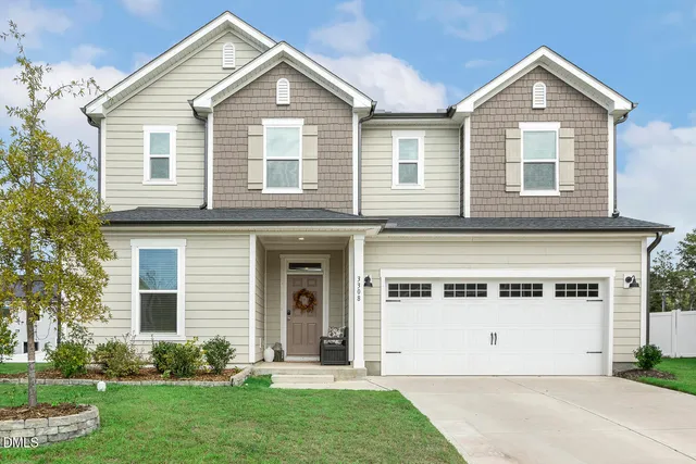 a front view of a house with a yard and garage