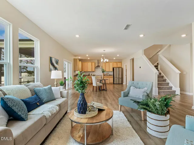 a living room with furniture and a potted plant