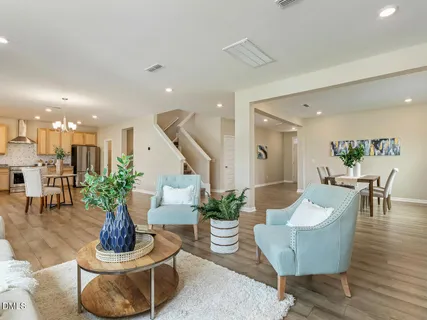 a view of a dining room with furniture wooden floor and chandelier