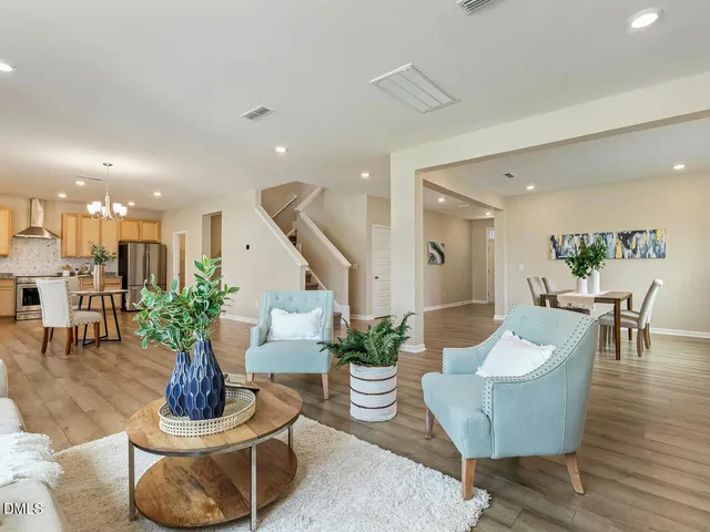 a view of a dining room with furniture wooden floor and chandelier