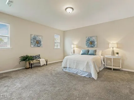 a spacious bedroom with a bed and a cabinets