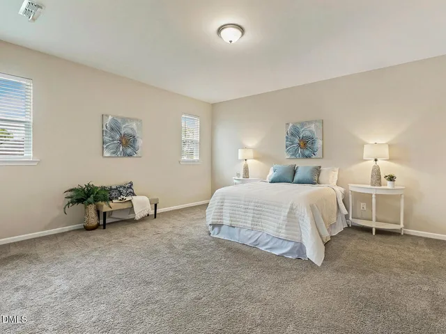 a spacious bedroom with a bed and a cabinets