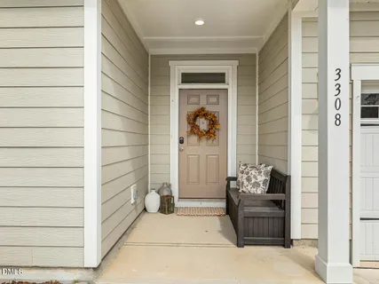 a view of a hallway with wooden floor and a chandelier