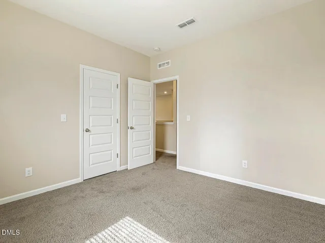 an aerial view of a house with a garden and yard
