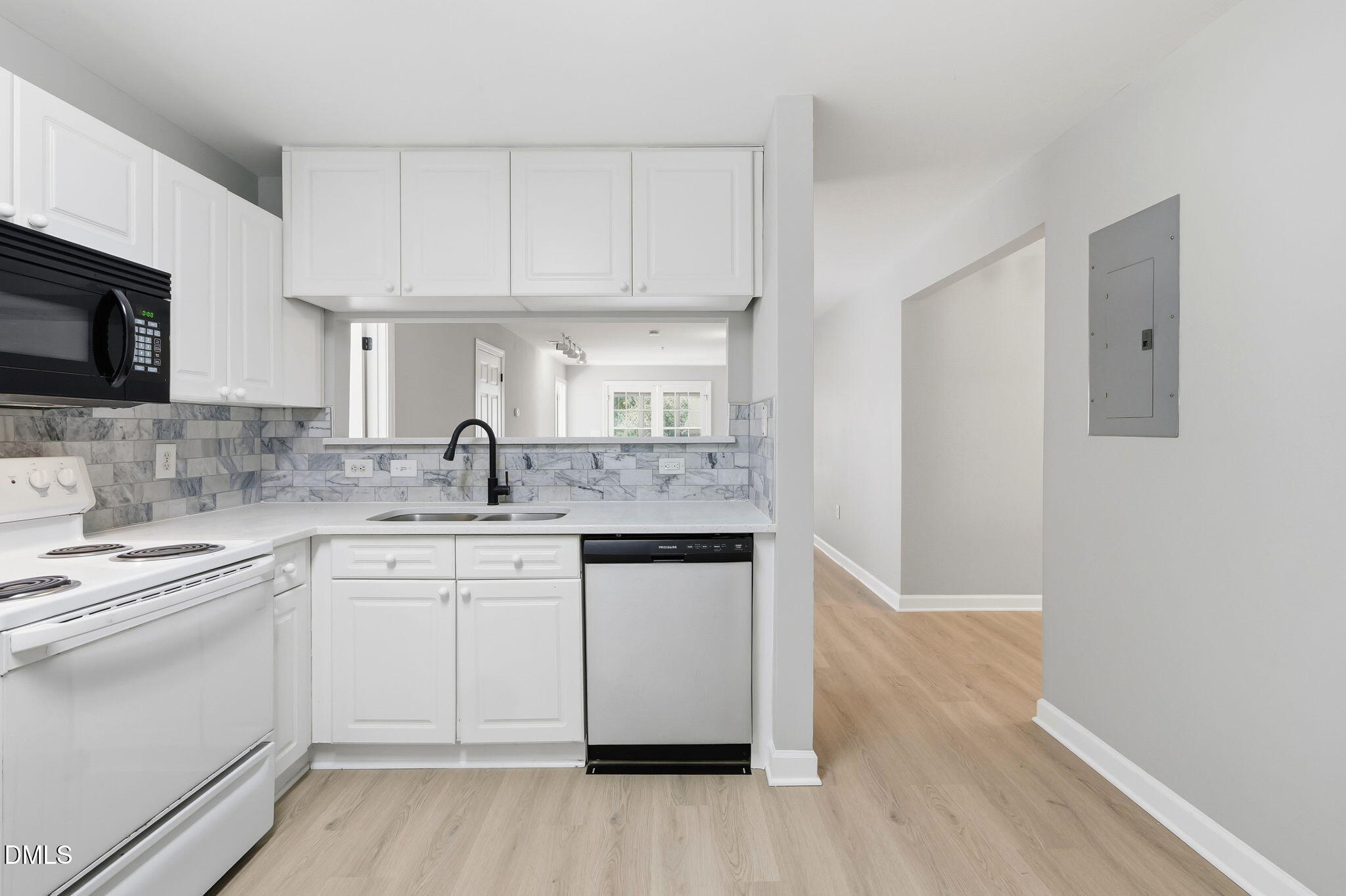 929 Morreene Road, Unit A23 Durham, NC 27705 - Photo 16 of 41 a kitchen with granite countertop white cabinets and white appliances