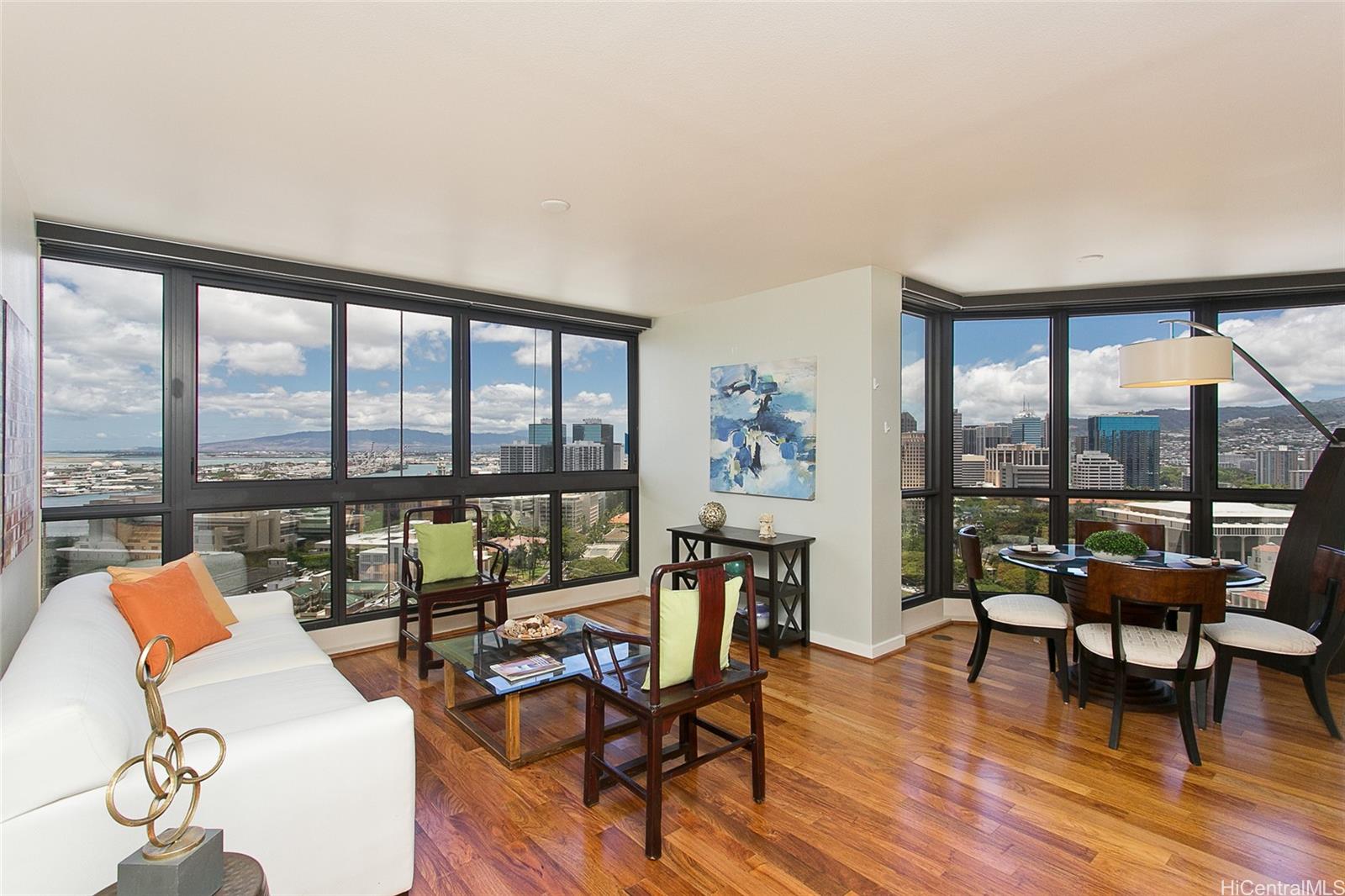 a living room with furniture and floor to ceiling windows