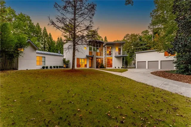 a front view of house with yard and trees