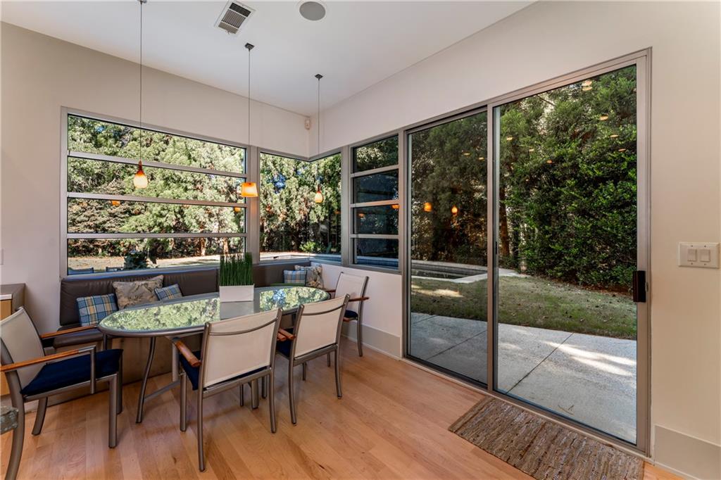 1775 Mt Paran Road Northwest Atlanta, GA 30327 - Photo 21 of 66 a dining room with furniture wooden floor and a floor to ceiling window