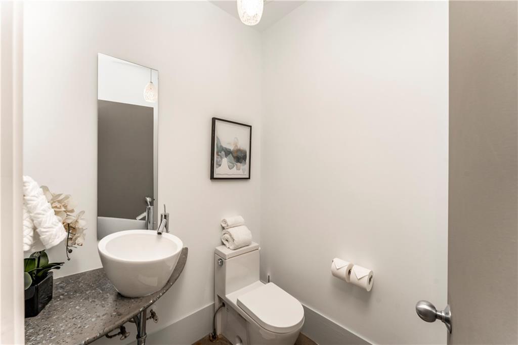 1775 Mt Paran Road Northwest Atlanta, GA 30327 - Photo 25 of 66 a bathroom with a toilet a sink and mirror