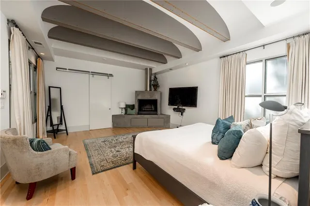 a bedroom with a bed and a window