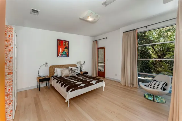 a view of a room with wooden floor and furniture