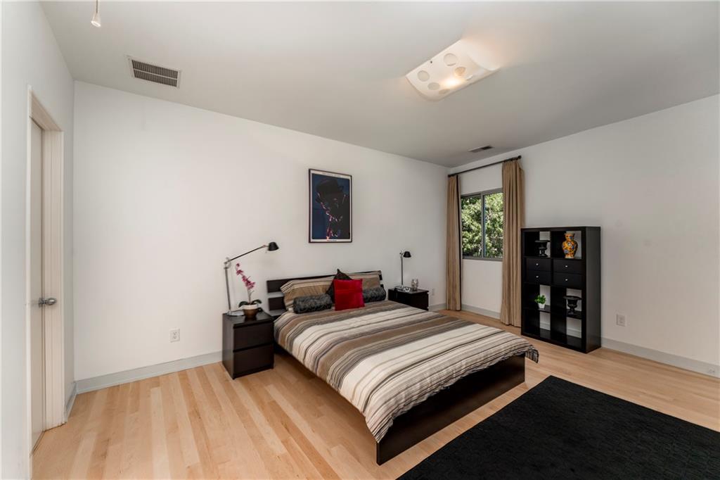 1775 Mt Paran Road Northwest Atlanta, GA 30327 - Photo 48 of 66 a bedroom with a large bed and a chandelier