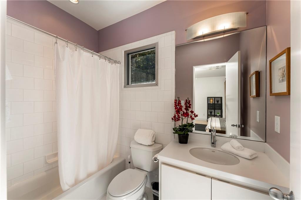 1775 Mt Paran Road Northwest Atlanta, GA 30327 - Photo 50 of 66 a bathroom with a sink vanity mirror and toilet