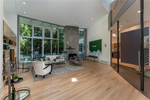 a view of hall way with furniture and floor to ceiling window