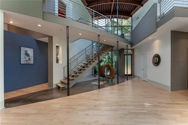 a living room with furniture fireplace and a large window