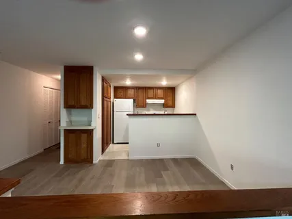 a view of a kitchen with a sink and a refrigerator