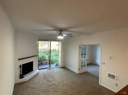 a view of a livingroom with an empty space and a fireplace