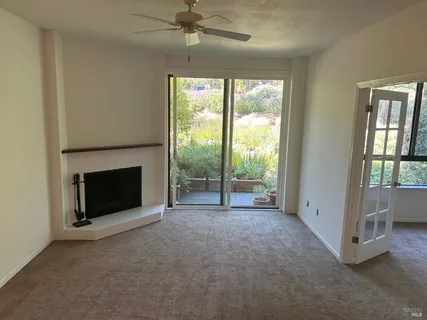 a view of an empty room with a fireplace