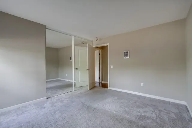 a bathroom with a granite countertop sink a toilet and shower
