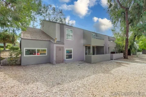 a view of a pathway of a house with potted plants