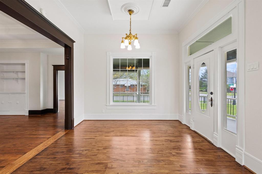 1001 West Morton Street Denison, TX 75020 - Photo 13 of 37 a view of an empty room with window and wooden floor