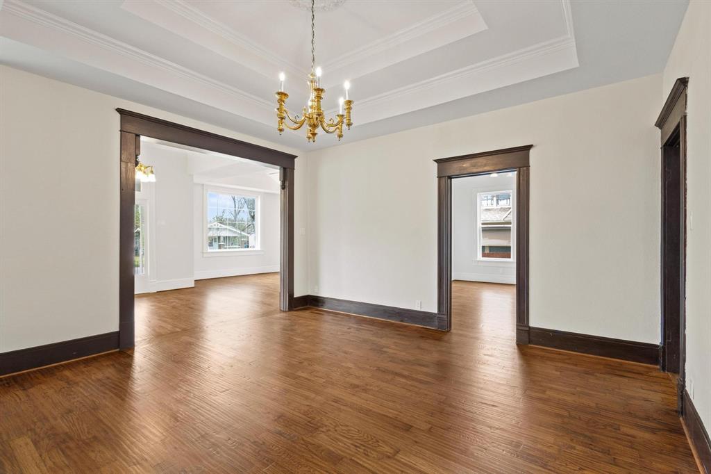 1001 West Morton Street Denison, TX 75020 - Photo 15 of 37 a view of an empty room with wooden floor and a ceiling fan