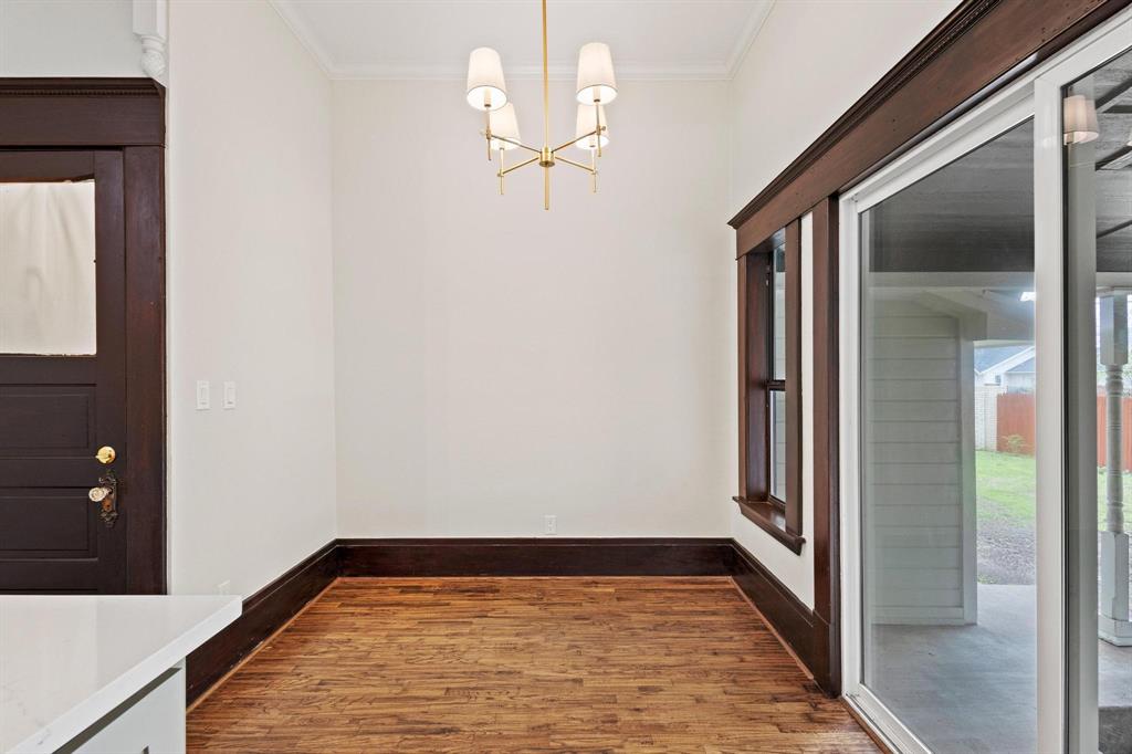 1001 West Morton Street Denison, TX 75020 - Photo 18 of 37 a view of a hallway with wooden floor and staircase