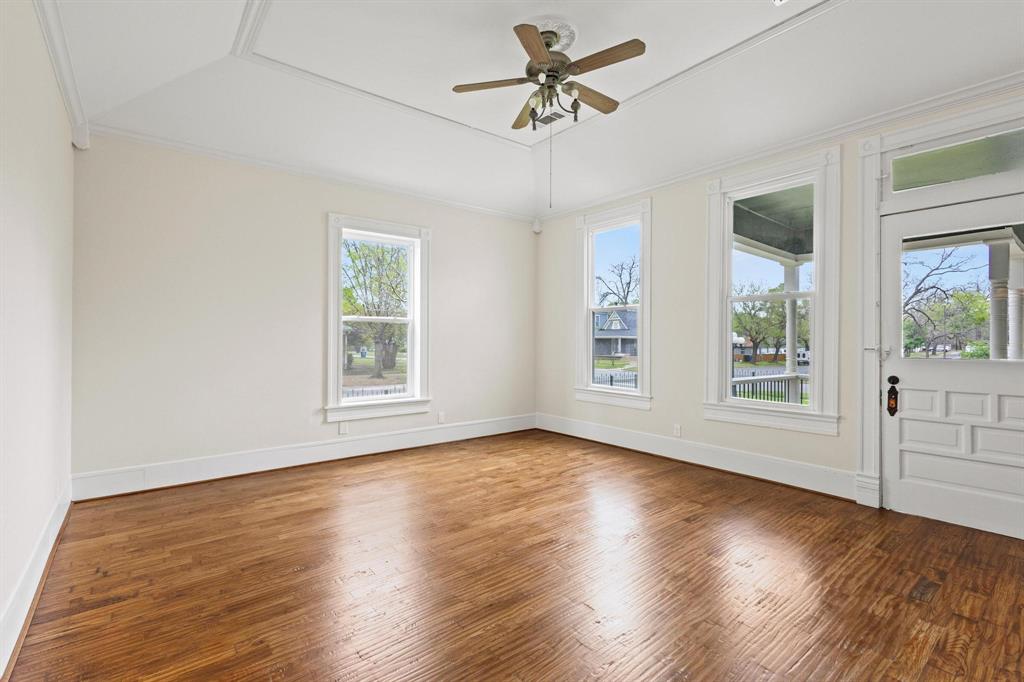 1001 West Morton Street Denison, TX 75020 - Photo 20 of 37 a view of an empty room with wooden floor and a window