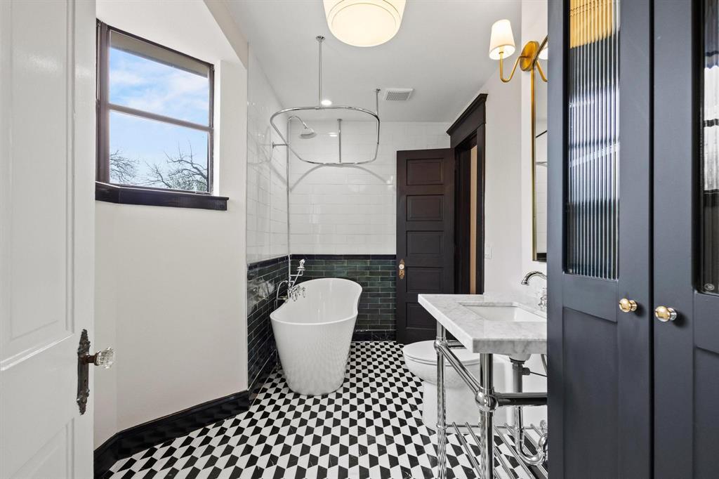 1001 West Morton Street Denison, TX 75020 - Photo 29 of 37 a bathroom with a sink a toilet and shower