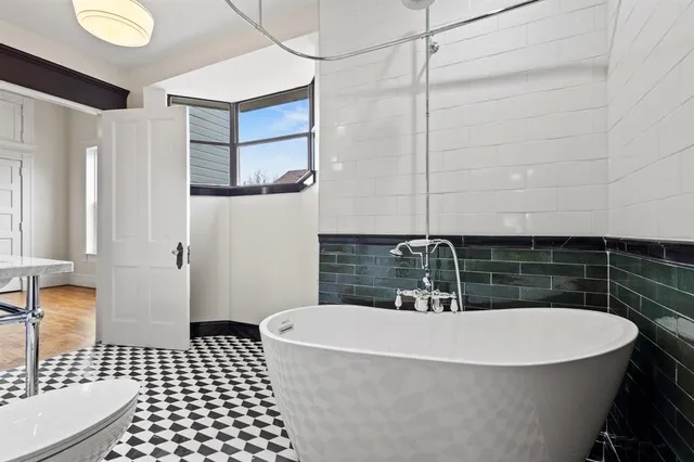 a bathroom with a bathtub and shower