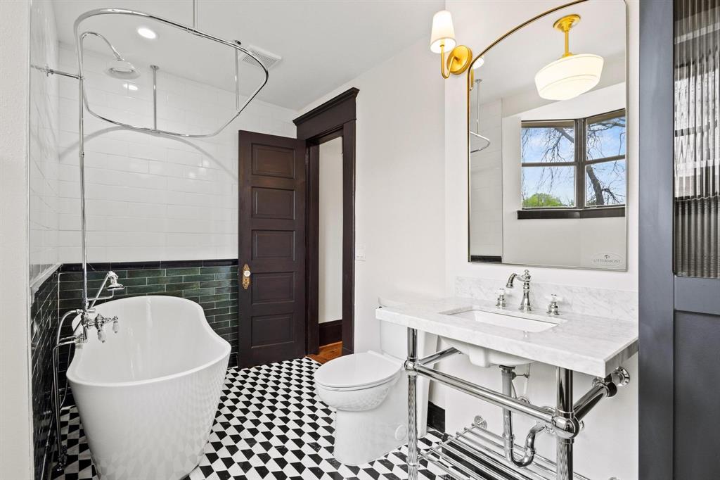 1001 West Morton Street Denison, TX 75020 - Photo 31 of 37 a bathroom with a sink a toilet and shower