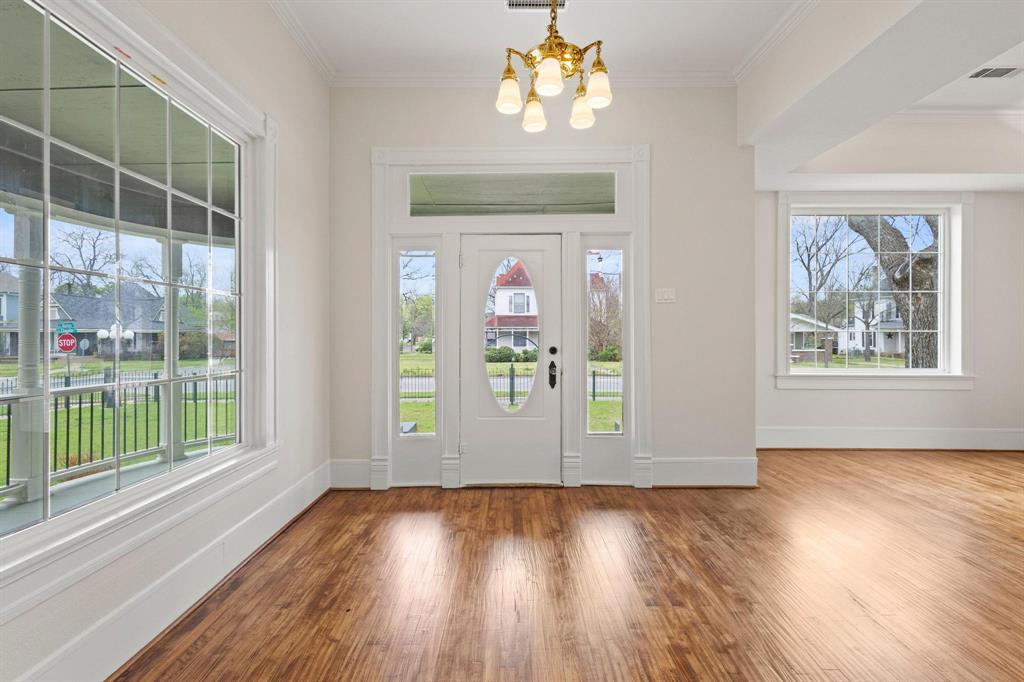 1001 West Morton Street Denison, TX 75020 - Photo 9 of 37 wooden floor in an empty room with a window